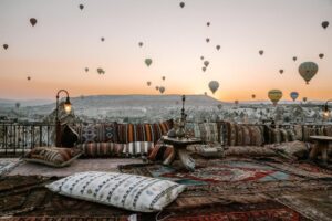 View from Koza Cave Hotel rooftop showing hot air balloons at eye level