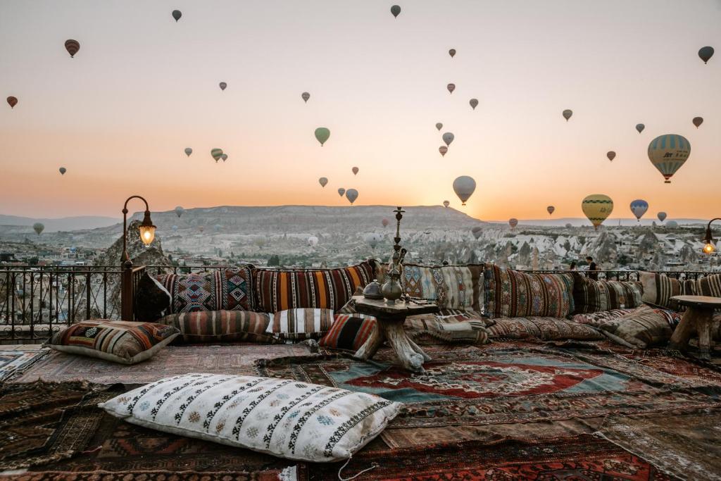 View from Koza Cave Hotel rooftop showing hot air balloons at eye level